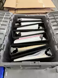 Image of Box Of Plastic Binders Filled